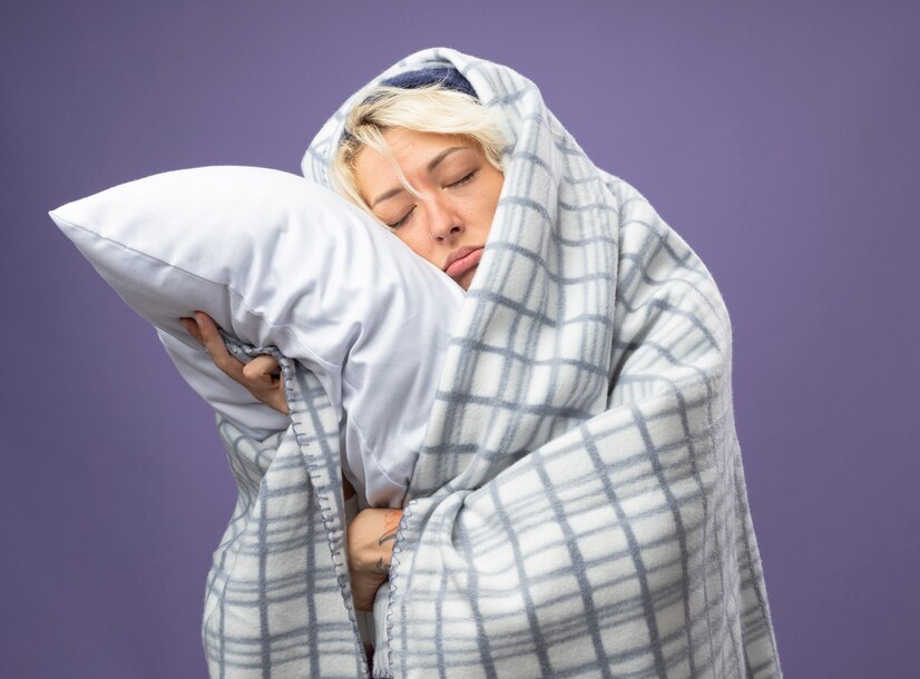 sick unhealthy woman with short hair warm hat wrapped blanket holding pillow leaning her head pillow with closed eyes unhappyover purple background 141793 49045 دکتر مهرداد حسین زاده بختوری